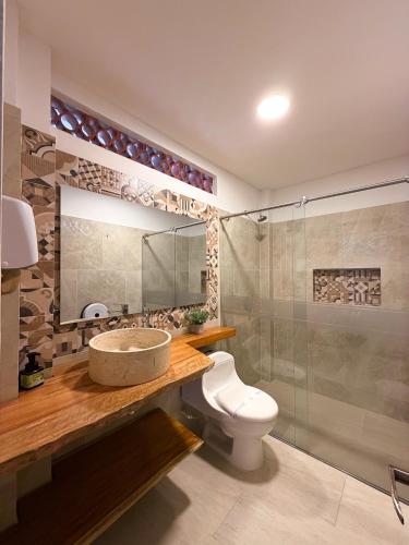 a bathroom with a sink and a toilet and a shower at Hotel Casa Oliveros in Rivera