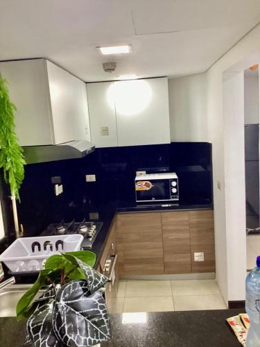 a kitchen with a sink and a microwave at Compound Porto New Cairo in Cairo
