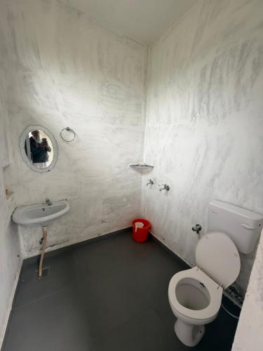 a bathroom with a toilet and a sink at Sir Mam Ashram in Bhaddi