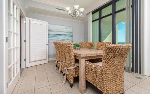 a dining room with a wooden table and chairs at Phoenix West 708 in Orange Beach