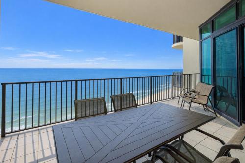 a balcony with a table and chairs and the ocean at Phoenix West 2008 in Orange Beach