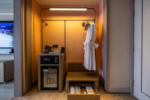 a room with a closet with a white umbrella and a door at Mercure Tianshui Downtown in Tianshui