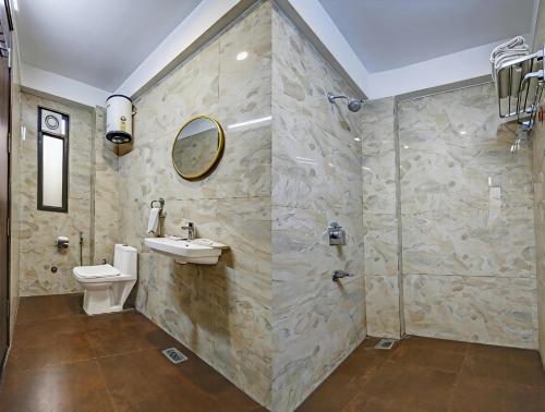 a bathroom with a sink and a shower at Hotel Ashram View With Luxury Near Nizamuddin Railway Station in New Delhi