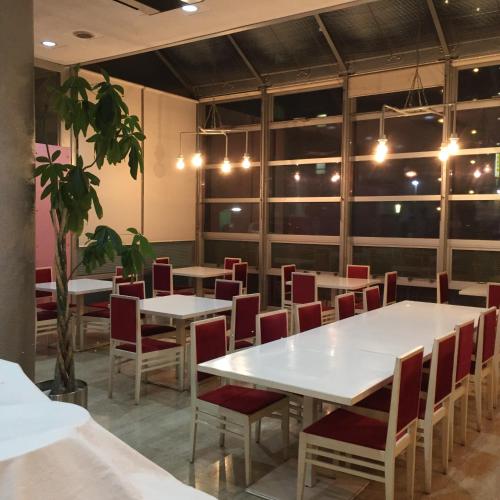 a room with tables and chairs and a plant at Hotel Crown Hills Kofu in Kofu