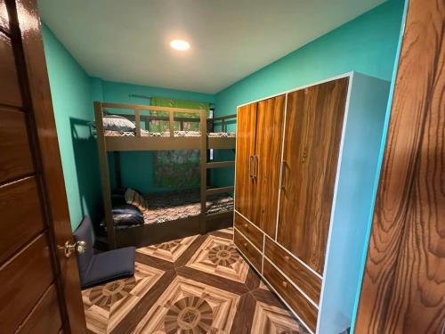 a room with two bunk beds and a door at Rjoyz transient house in Itogon