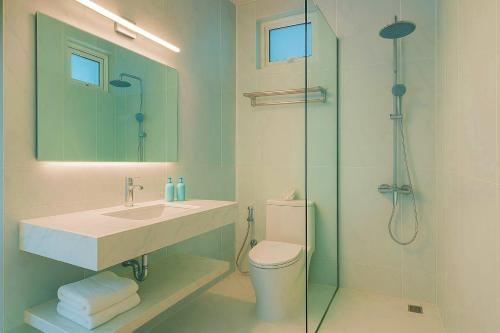 a bathroom with a sink and a shower and a toilet at Cher resort Maldives in Kamadhoo