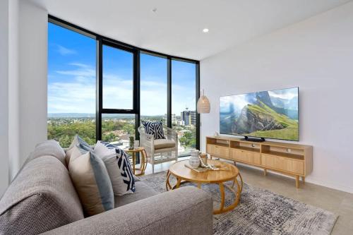 a living room with a couch and a large window at The Gallery Broadbeach - Hosted by Gold Coast Luxury Resorts in Gold Coast