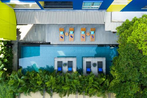 an overhead view of a swimming pool with chairs and trees at LiT BANGKOK Residence in Bangkok