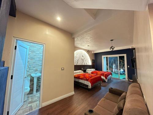 a bedroom with a bed and a couch in a room at Casa Lolita in San Juan La Laguna