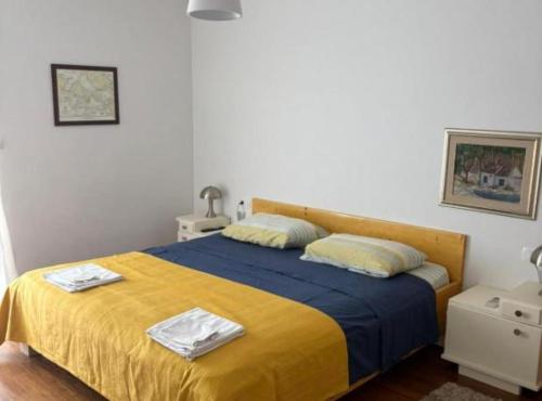 a bedroom with a bed with a yellow blanket at Villa Coral in Novo Selo