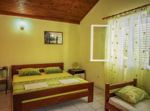 a bedroom with a bed and a window at Nirvana Apartments & Auto Camp in Kumbor