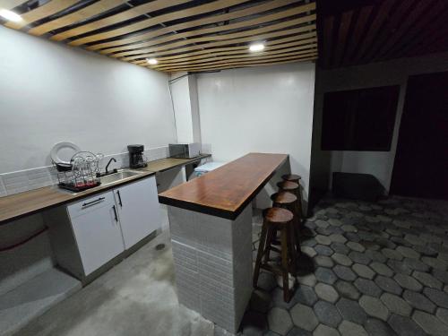 a large kitchen with a counter in a room at Casa Rayon Oaxaca in Oaxaca City