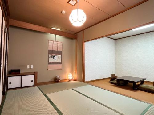 a room with a table and a room with a window at Renovated room! Japanese inn Matsumoto in Ichinoseki