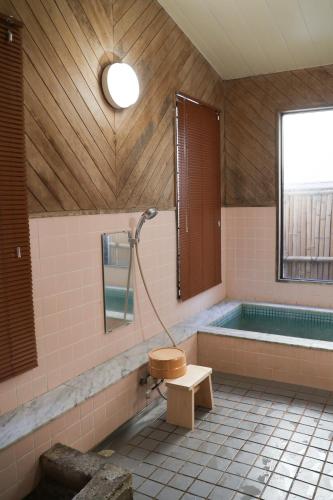 a bathroom with a tub and a toilet and a shower at Renovated room! Japanese inn Matsumoto in Ichinoseki