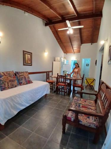 a woman sitting at a table in a room at CHALET económico cerca del Mar in Costa Azul