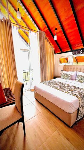 a bedroom with a large bed with a red ceiling at The Misty Crown in Hatton