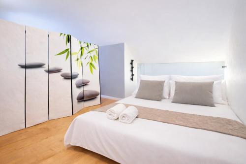 a bedroom with a white bed with towels on it at Luxury Loft Duplex Penthouse Of 190m2 & Free Parking ! in Brussels