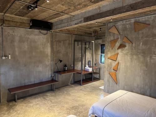 a bedroom with a bed and a desk in it at The Lumpang Resort in Kerling