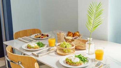 a breakfast table with plates of food and drinks at Goseong Gamnamu Pension in Goseong