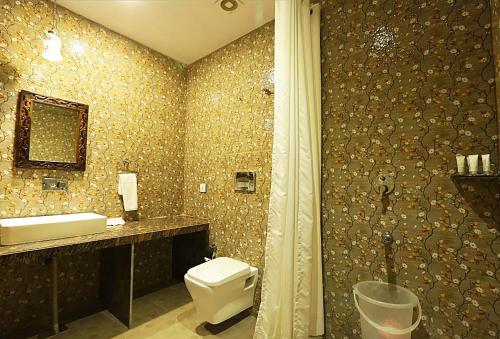 a bathroom with a toilet and a sink at The Byke - The Sanctuary Heritage - Pan India Pure Veg Hotel Chain in Kumbhalgarh