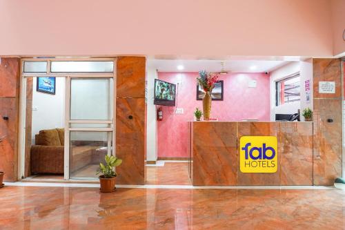 a living room with a sliding glass door and a couch at FabHotel Rachana Residency - Nr Shivaji Nagar Metro Station in Pune