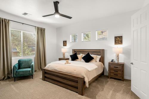 a bedroom with a bed and a blue chair at McB's Mountain Retreat in Flagstaff