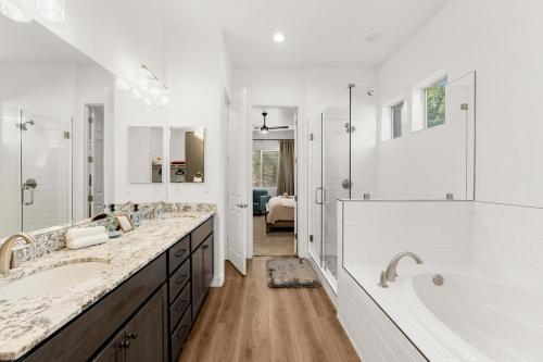 a white bathroom with two sinks and a tub at McB's Mountain Retreat in Flagstaff