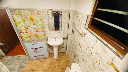 a bathroom with a toilet and a sink at Mangala gust house in Habaraduwa Central