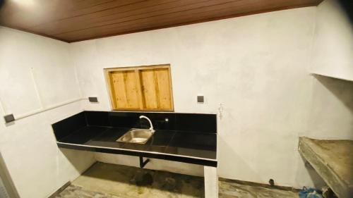 a kitchen with a sink and a window at Mangala gust house in Habaraduwa Central