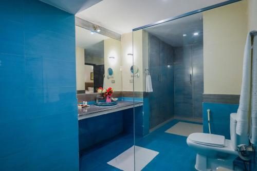 a bathroom with a glass shower and a toilet at Hotel One Bahawalpur in Bahawalpur