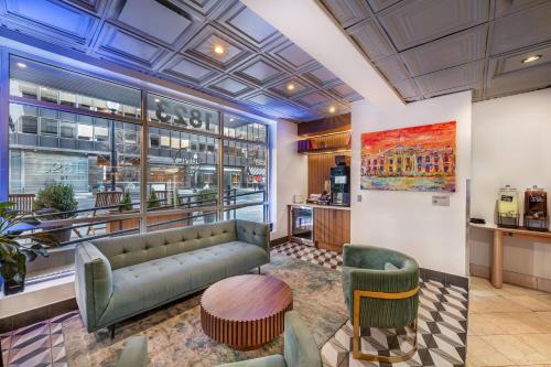 a lobby of a store with a couch and chairs at The Quincy, an Ascend Collection Hotel in Washington, D.C.