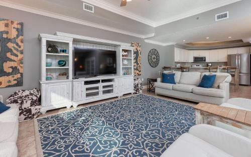 a living room with a tv and a couch at Phoenix West 2203 in Orange Beach