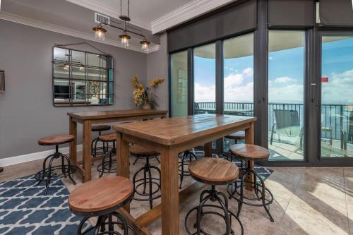 a dining room with a table and stools at Phoenix West 2203 in Orange Beach