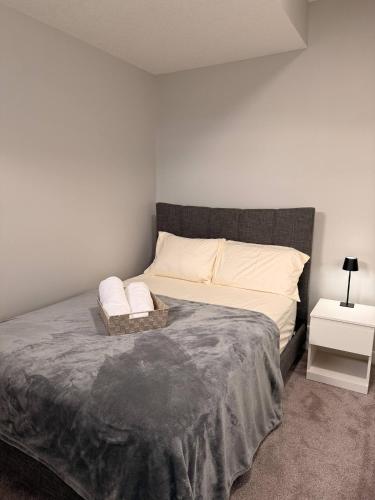 a bedroom with a large bed with white pillows at Cozy and comfortable in Calgary
