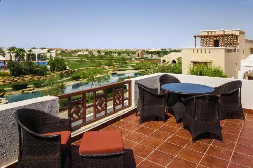 a patio with a table and chairs on a balcony at InterContinental Durrat Al Riyadh Resort & Spa by IHG in Riyadh