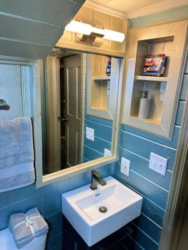a bathroom with a sink and a mirror at The Hideout in Moorhead