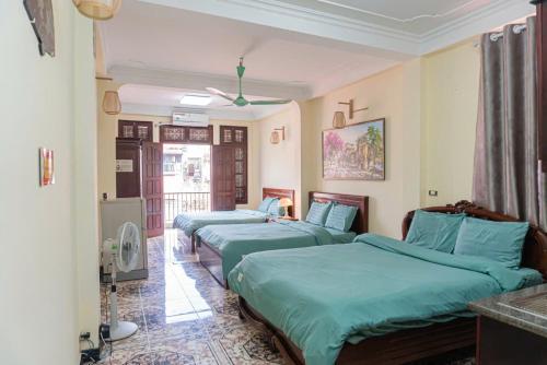 a room with three beds in a room at IL Divo Hostel 8 Hàng Đào & Travel & Spa - Hanoi Old Quarter in Hanoi