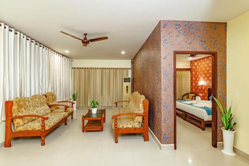 a hotel room with a bed and a bedroom at Hotel Lals Residency, Adoor in Adūr
