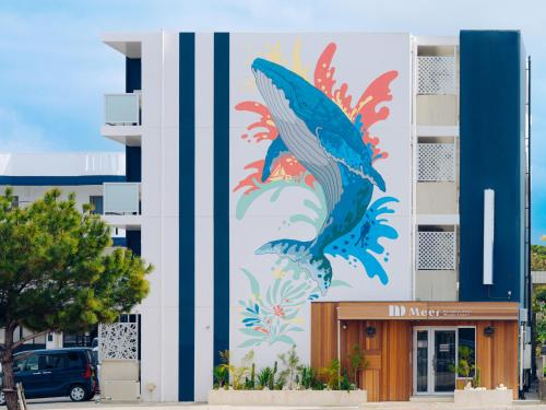 a mural of a fish on the side of a building at メーアレジデンスホテル 宮古空港前 - Meer Residence Hotel Miyako Airport - in Miyako-jima
