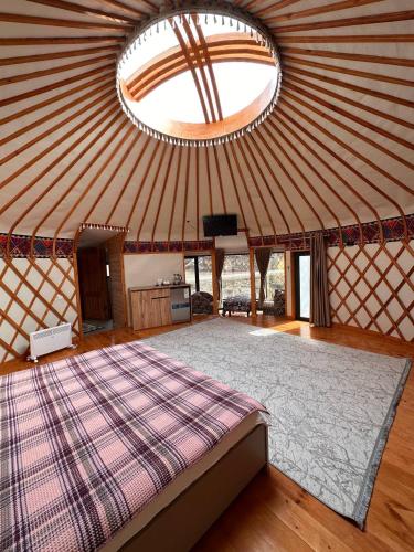 a large room with a bed in a yurt at RAHMAT yurts in Bishkek