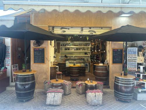 a store with a bunch of barrels and umbrellas at MmeBassia in Chania