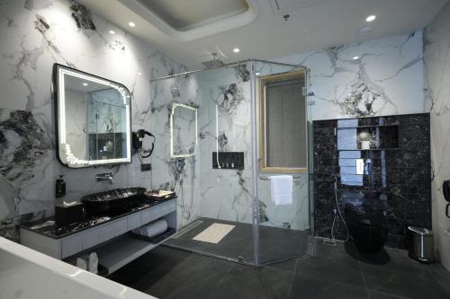 a bathroom with a shower and a sink at The Surya Golden Palace, Pushkar in Pushkar
