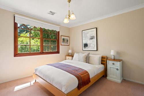 a bedroom with a large bed and a window at Chestnut Tree Farm in Werai