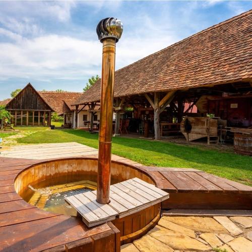 a wooden fountain with a street light on a wooden deck at Șura din Seleuș - Seleuș Barn - Idyllic Countryside M Museum House in Sighişoara