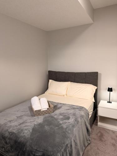 a bedroom with a large bed with two pillows at Casa Gabriel in YYC