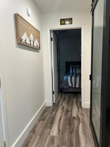 a hallway with a door to a bedroom with a bed at Lake Shastina Golf Resort in Weed