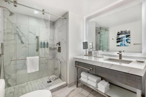 a bathroom with a sink and a shower at Hilton Grand Vacations Club Chicago Magnificent Mile in Chicago
