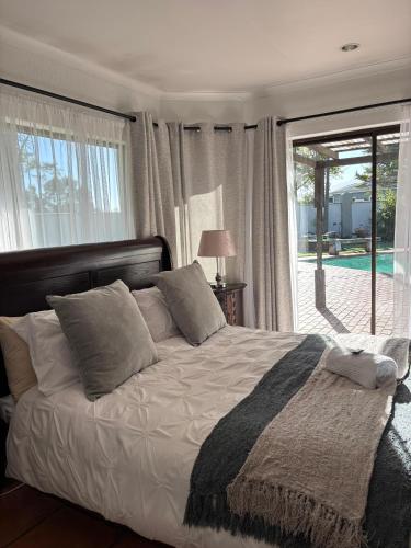 a bedroom with a bed and a large window at The Hops Inn in George