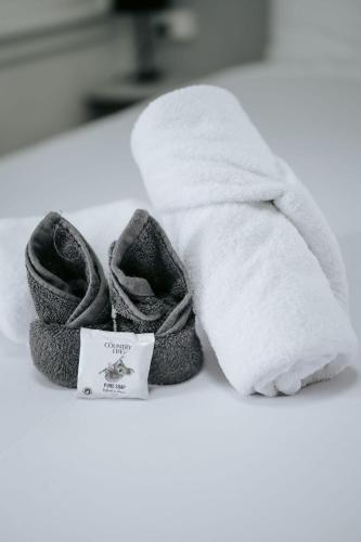 a pair of slippers next to a white towel at Rix Hotel Motel in Charters Towers