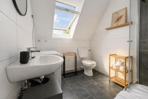 a bathroom with a sink and a toilet at Emden City Center - Innenstadt in Emden